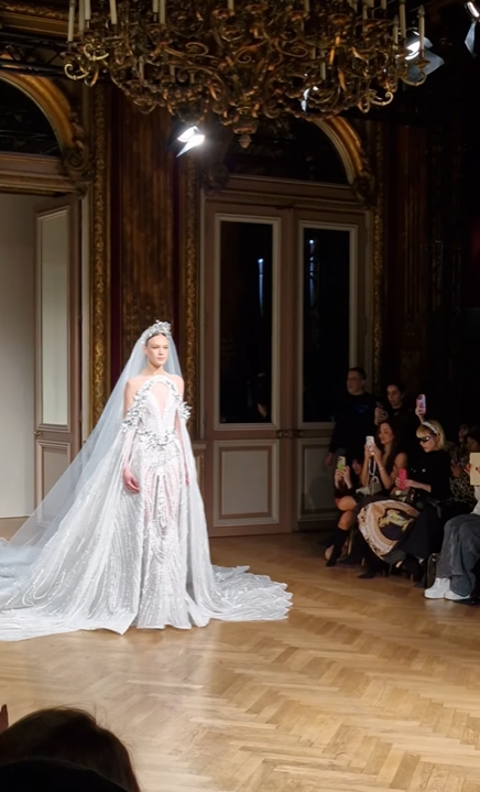 Ziad Nakad’s SS Haute Couture 2025 Bridal gown epitomizes the designer’s signature blend of intricate craftsmanship and ethereal elegance.